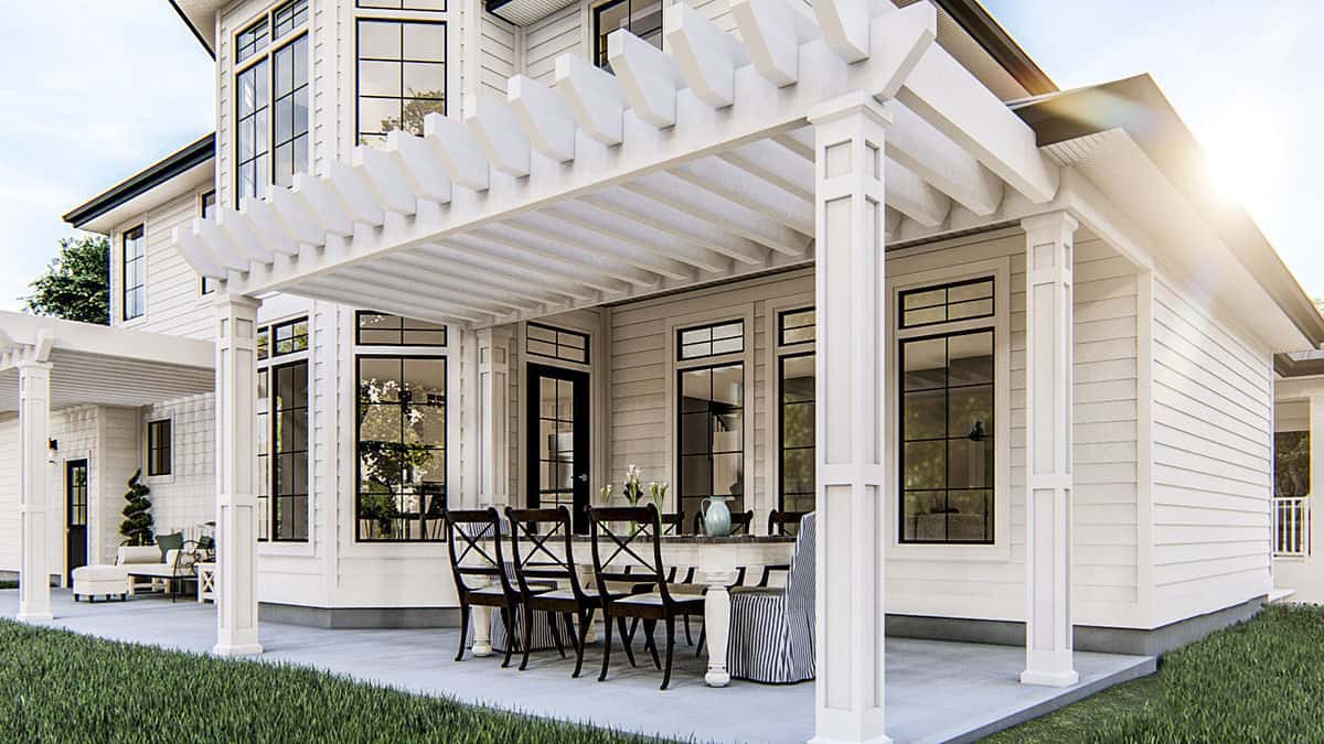 The pergola porch features an outdoor dining set over concrete flooring.