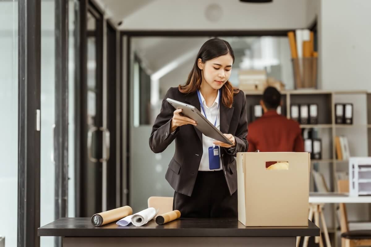 Employee exit process: employee putting her things in a box