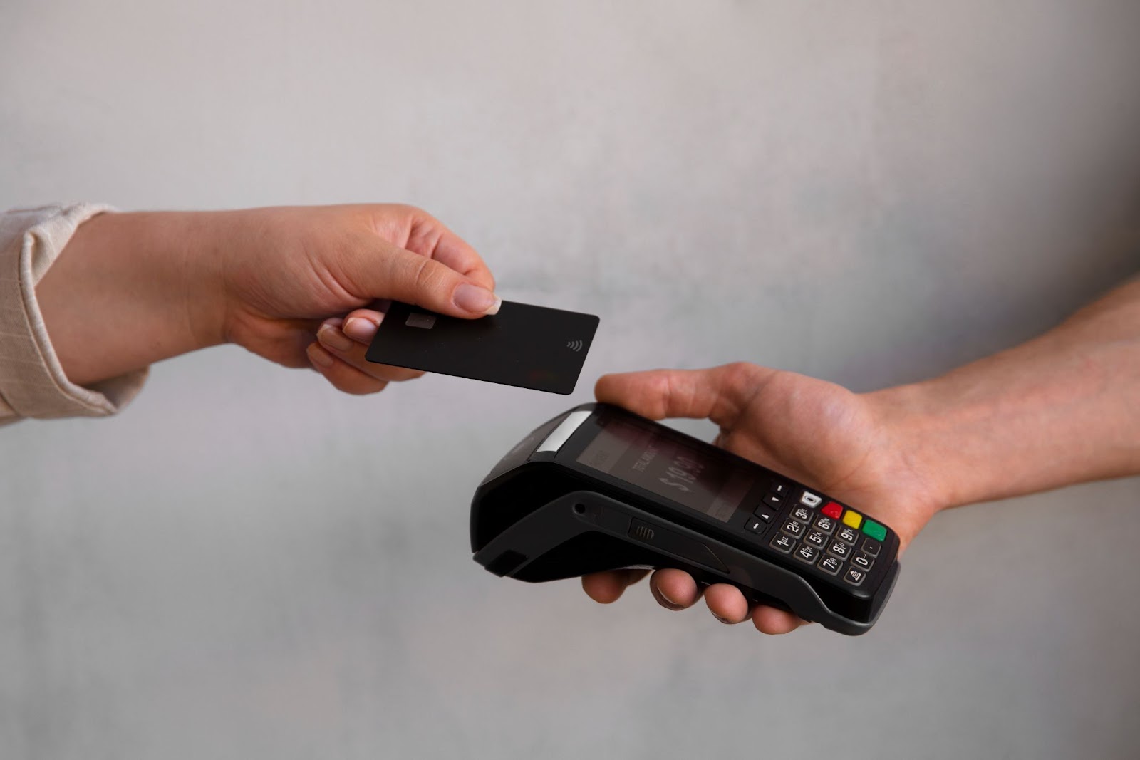 person using credit card to pay for transaction