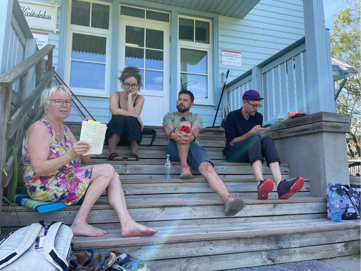 A group of people sitting on stairs outside a buildingAI-generated content may be incorrect