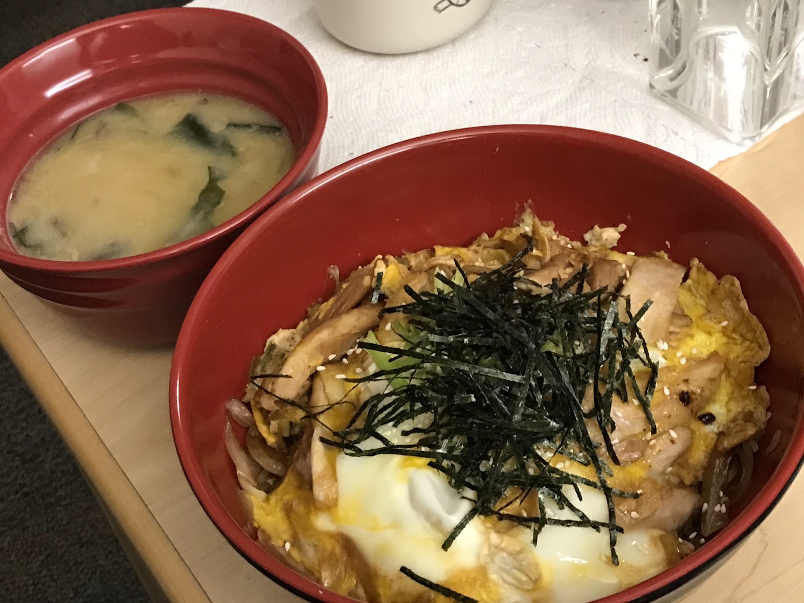 Two red bowls of different recipes.