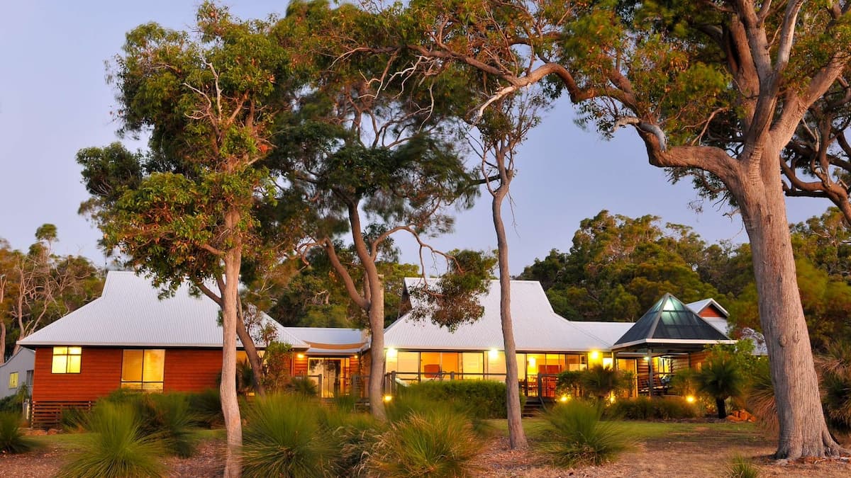 Exterior of the Chez Nous property surrounded by tall trees