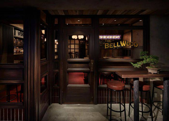 The exterior of The Bellwood, featuring dark woods, red leathers and an inviting decor.