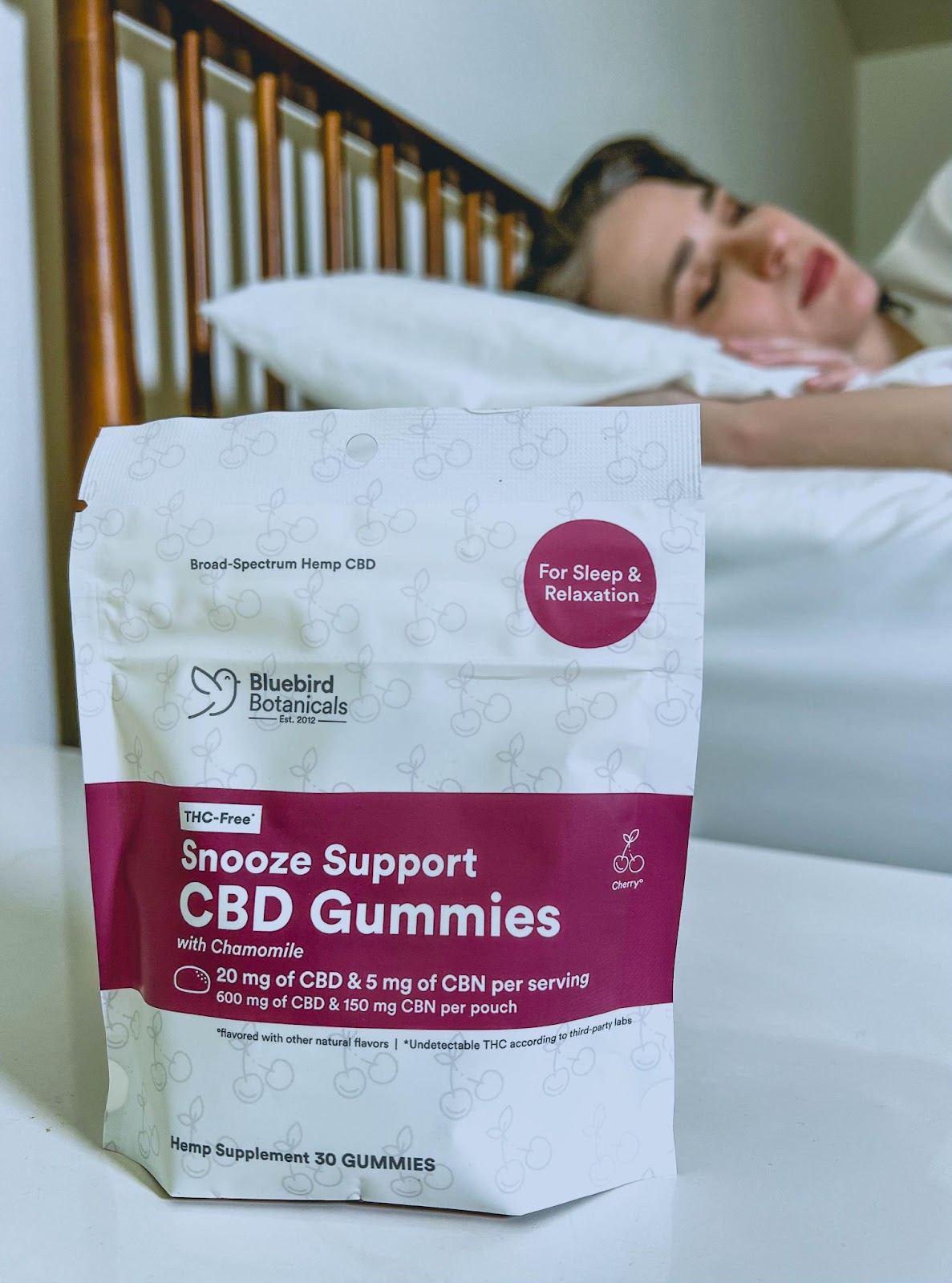 Bluebird Snooze Support CBD gummies for sleep placed on bedside table to promote restful night