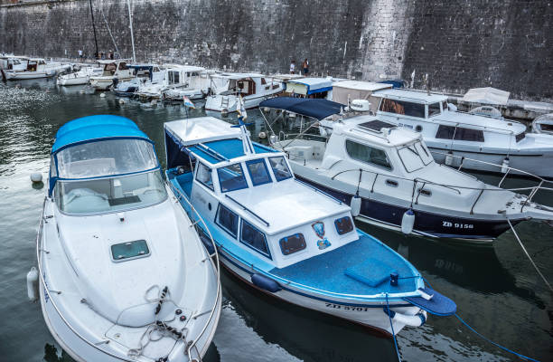 Two boats moving side by side, with fenders in place for protection.