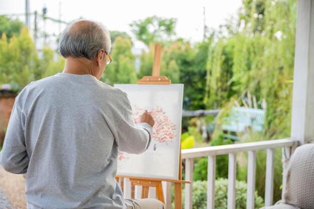 A person painting on a canvas

Description automatically generated