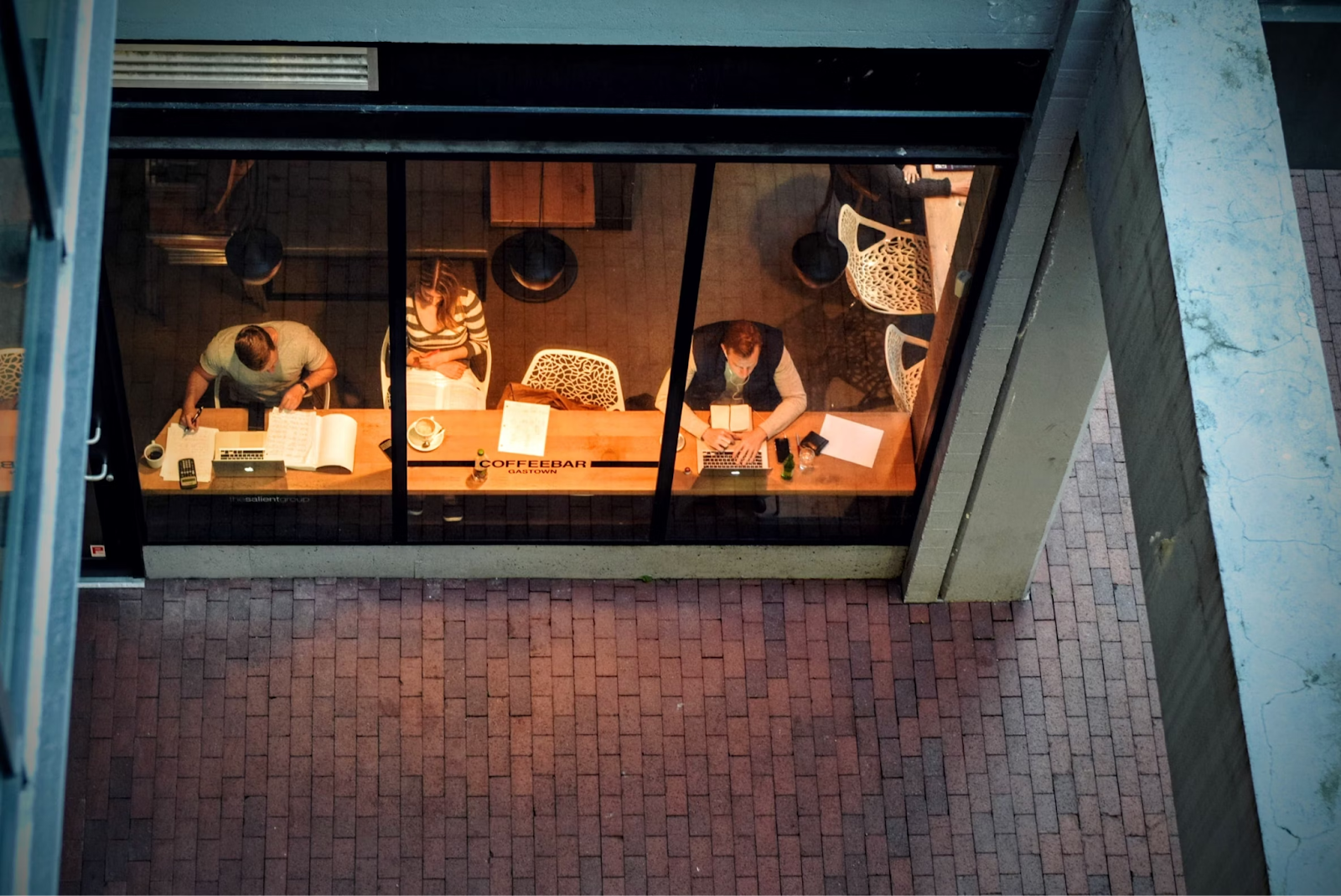 Freelancers working in a cafe using laptops and books