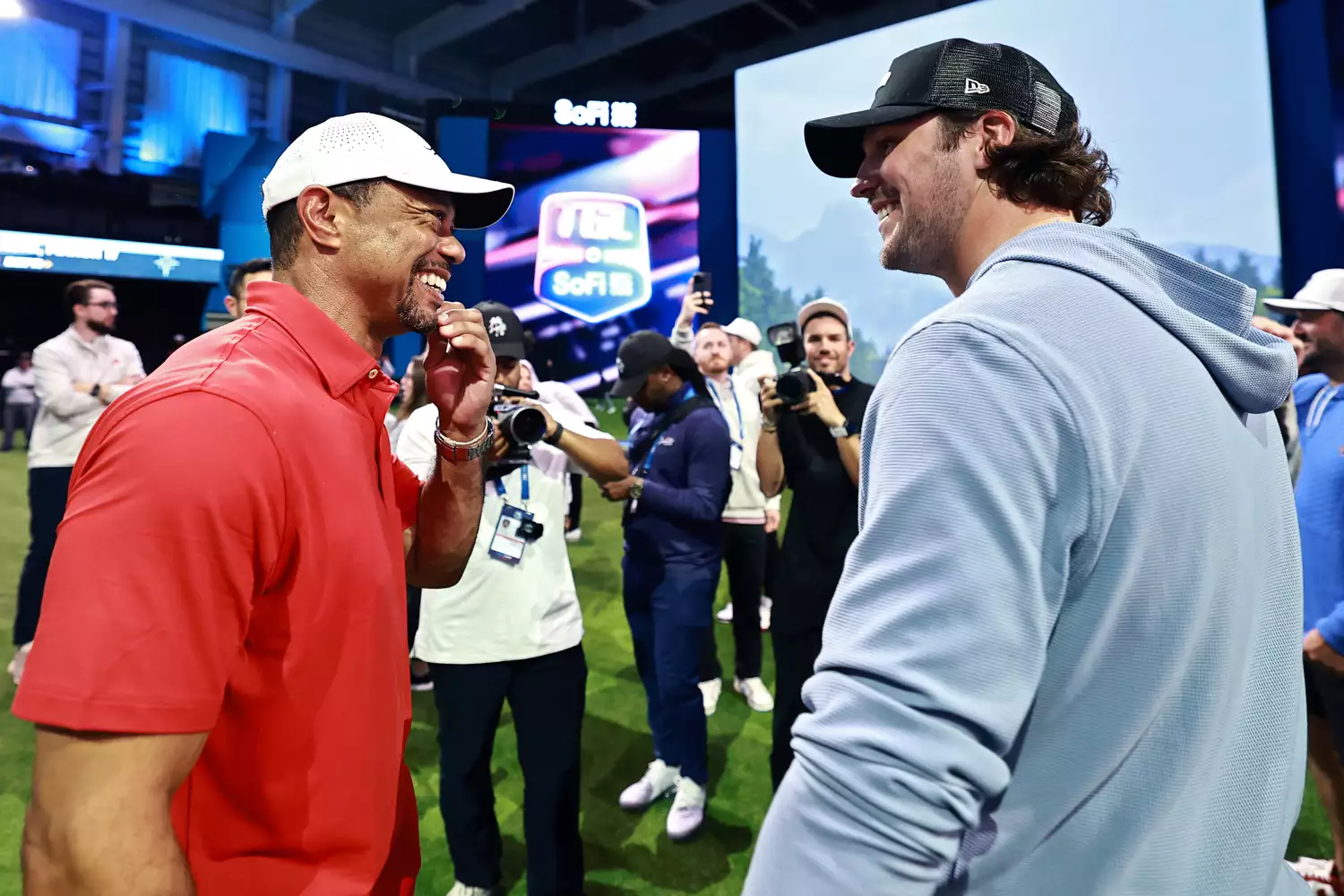Tiger Woods of Jupiter Links Golf Club and Josh Allen of the Buffalo Bills discussing Josh Allen's bachelor party after their TGL match on March 4, 2025.