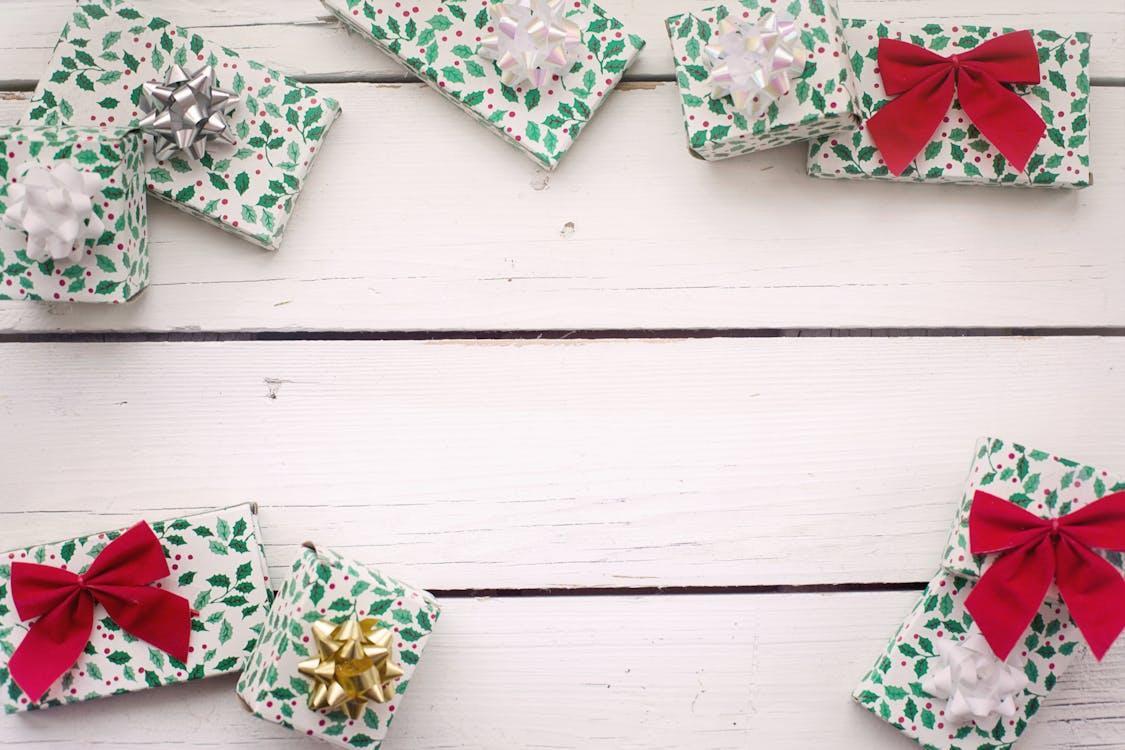 Free Photo of Christmas Gifts on Wooden Surface Stock Photo