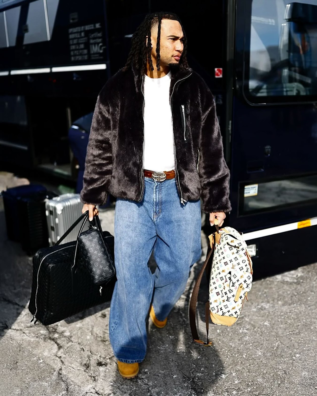 Photo shared by blitzfits on January 18, 2025 tagging @houstontexans, and @cj7stroud. May be an image of 1 person, overcoat, suitcase, goosedown coat, fur coat, briefcase, portable cassette player, luggage and text.