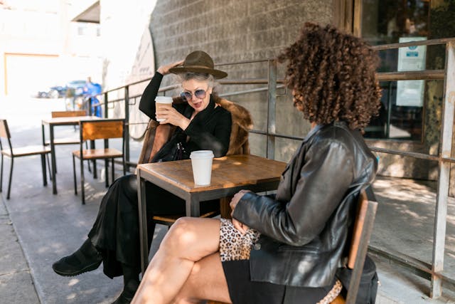 Two women drinking coffees