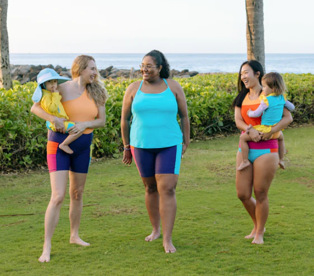 Women with children dressed in neon modest tankini sets by SwimZip for coverage and comfort—Cute modest bathing suits for coverage and style