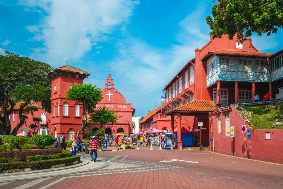 A red building with a cross on it

Description automatically generated