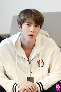 A picture of Jin in  white hoody