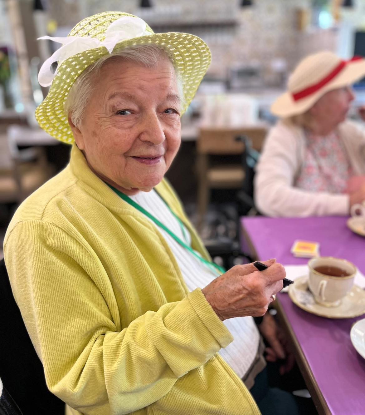 A picture of a woman sipping tea in an independent living facility