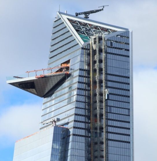 Final stages of construction on a downtown skyscraper.