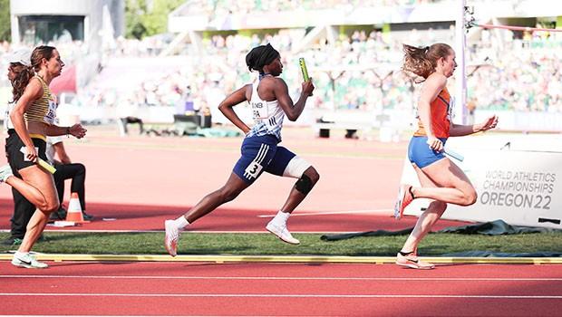 A group of women running on a track

Description automatically generated