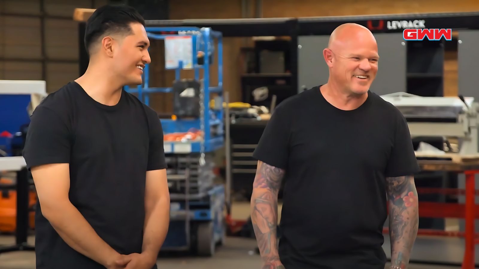 Tex Mex Motors team members smiling during a workshop restoration project.