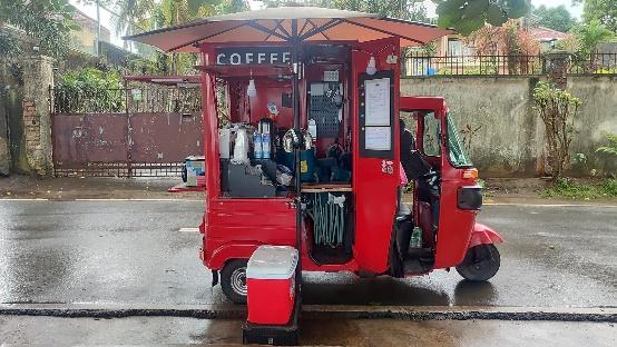 A red coffee truck with a canopy

Description automatically generated with medium confidence