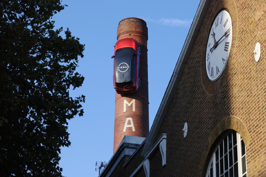 A Nissan Qashqai attached vertically to a chimney