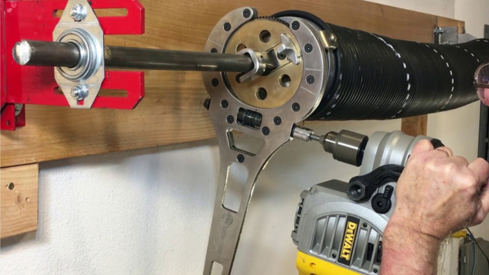 Installing garage door springs with precision tools.