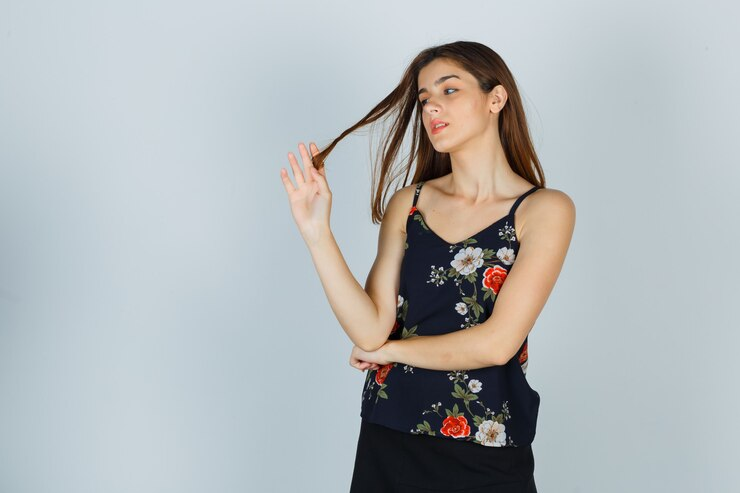 A young woman twirling hair around her fingers