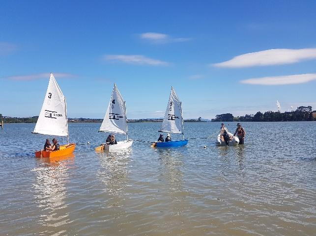 A group of people in small boats on water AI-generated content may be incorrect.