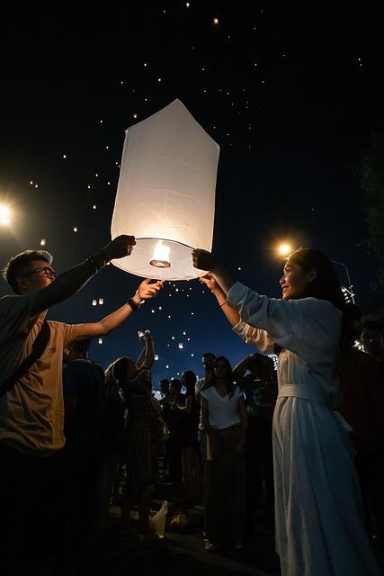 A group of people holding up a lantern

Description automatically generated