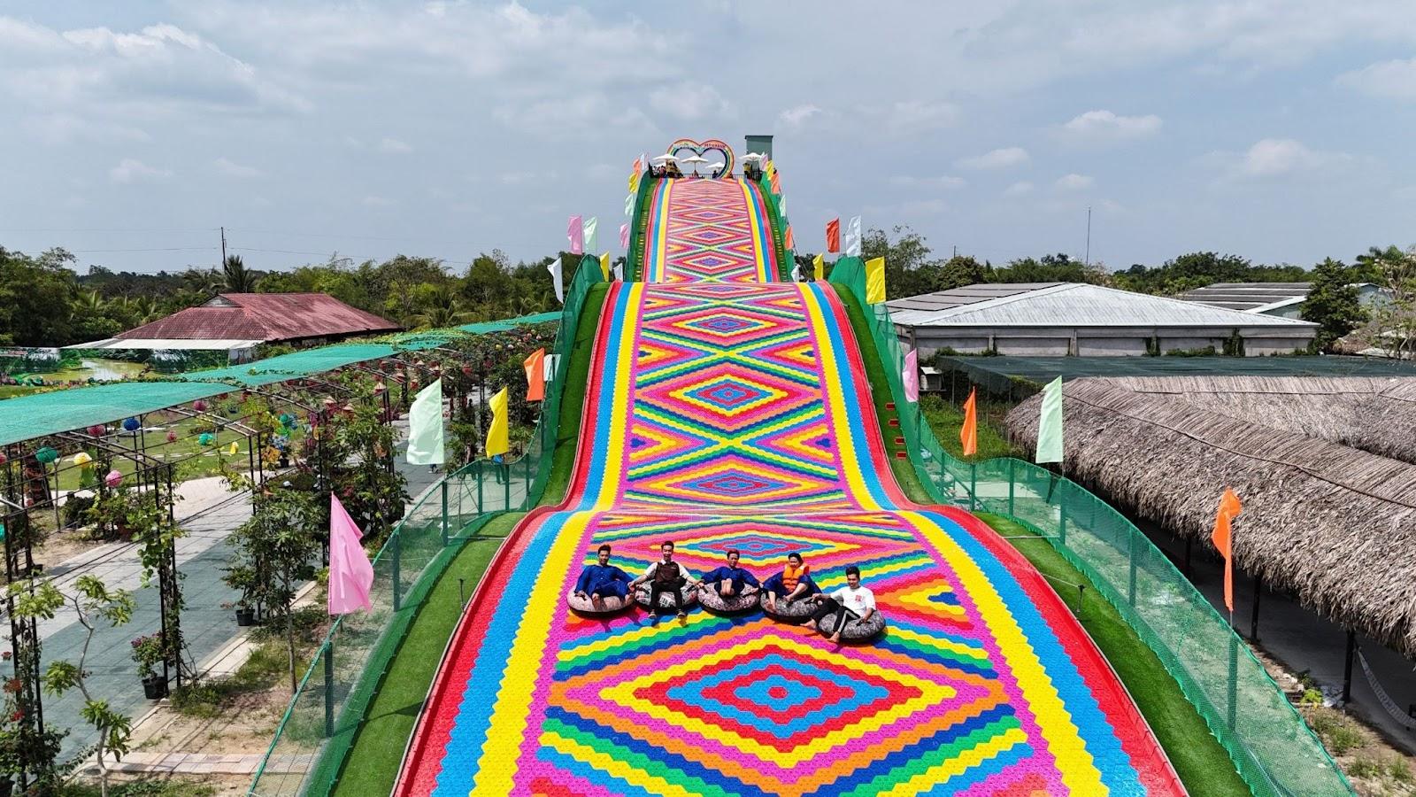 A group of people on tubing on a colorful carpetDescription automatically generated