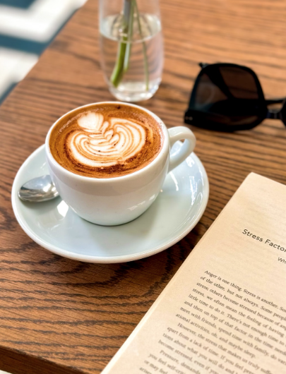 MLA style short story citation
.A coffee sits on a table next to an open book and a pair of sunglasses. 
