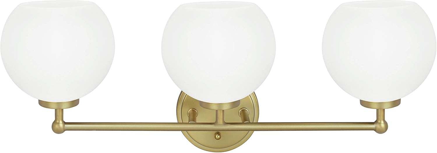 A modern brass vanity light with three frosted glass globe shades, ideal for bathroom wall.