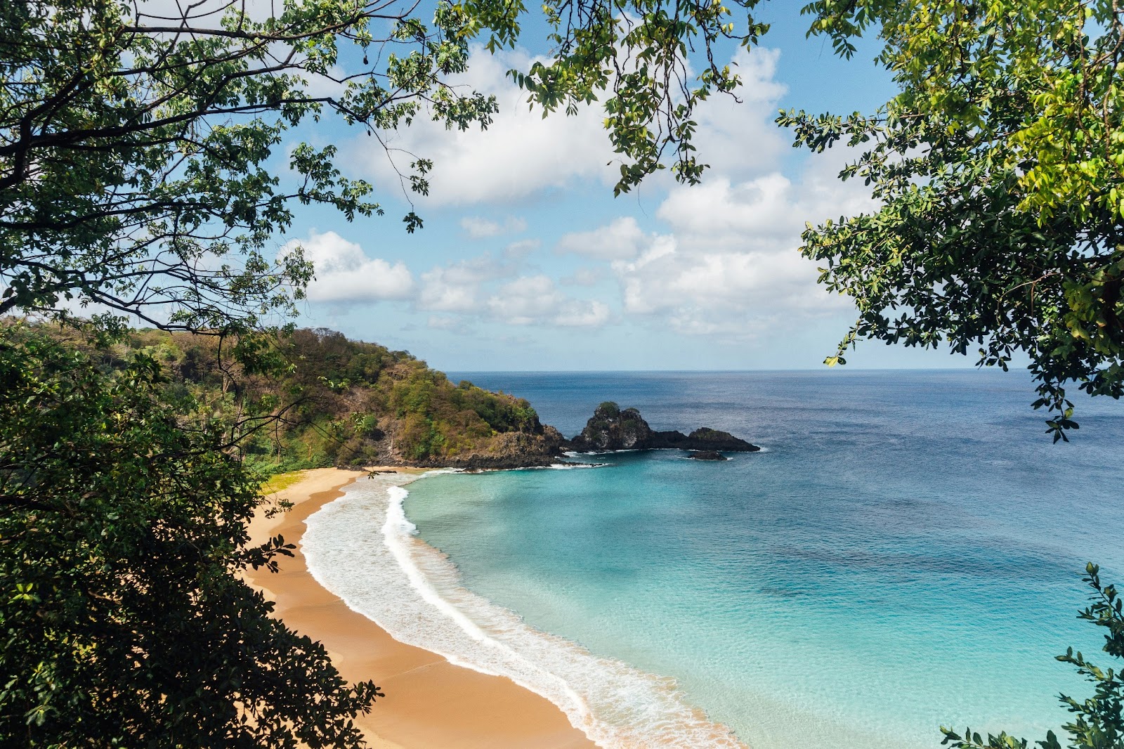 Aerial view of Praia do Sancho beach in Fernando de Noronha, showcasing the crystal-clear waters and rugged cliffs