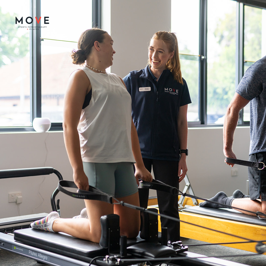 Clinical Pilates Move Sports Physio in Geelong Physio helping client on a reformer in high kneeling