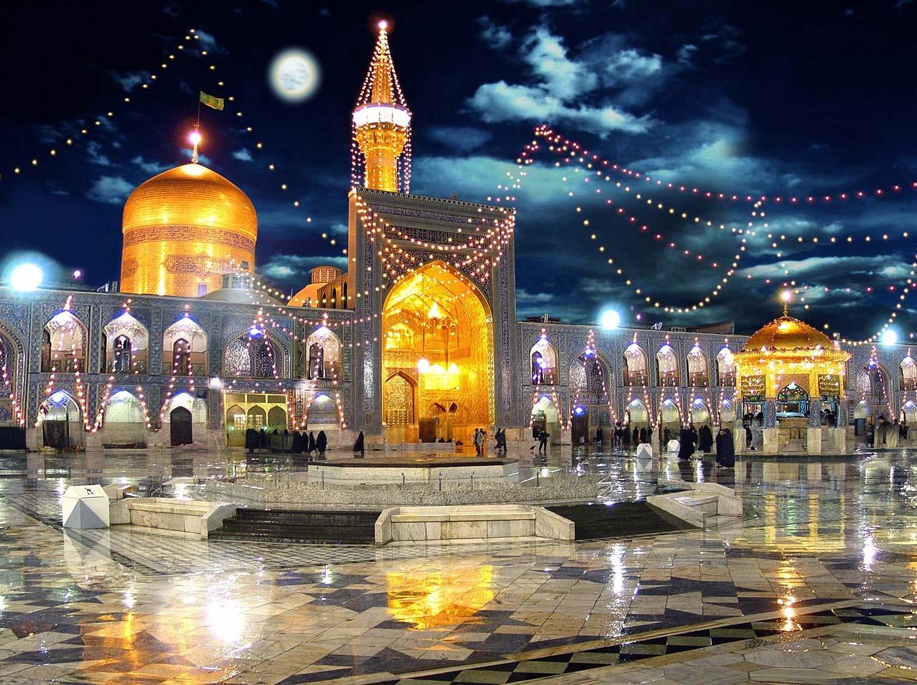 Night view of the illuminated Imam Reza Shrine in Mashhad, Iran, with golden domes, minarets, and decorative lights reflecting on the marble courtyard under a moonlit sky.