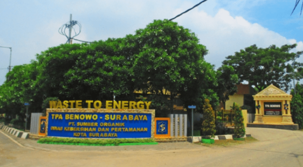 A sign with a large tree in the background

Description automatically generated