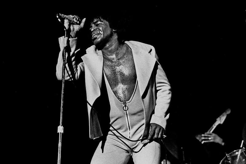 A black and white photo of James Brown singing live in Hamburg in 1973. 