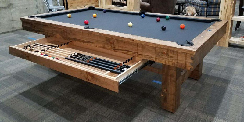 Pool table with a built in storage drawer.