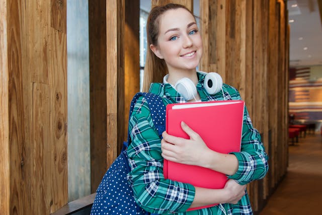 university student holding textbooks