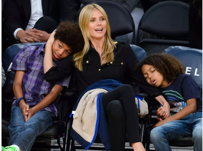 a younger Johan Riley Fyodor Taiwo Samuel with his mother and brother at an event