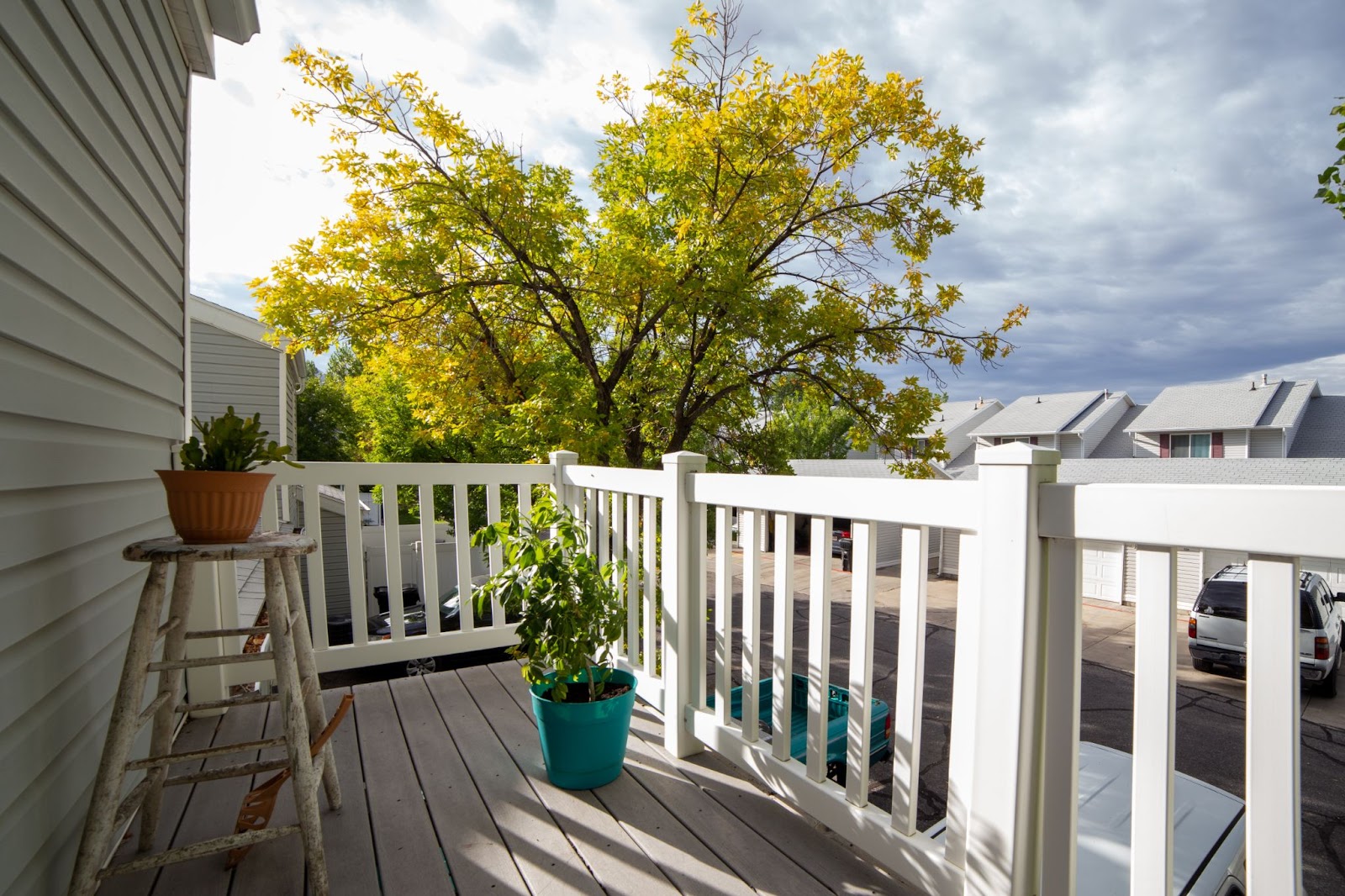 Vinyl deck rails next to potted plants. 