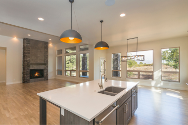 pros and cons of open concept floor plans large kitchen space with view of fireplace area custom built michigan