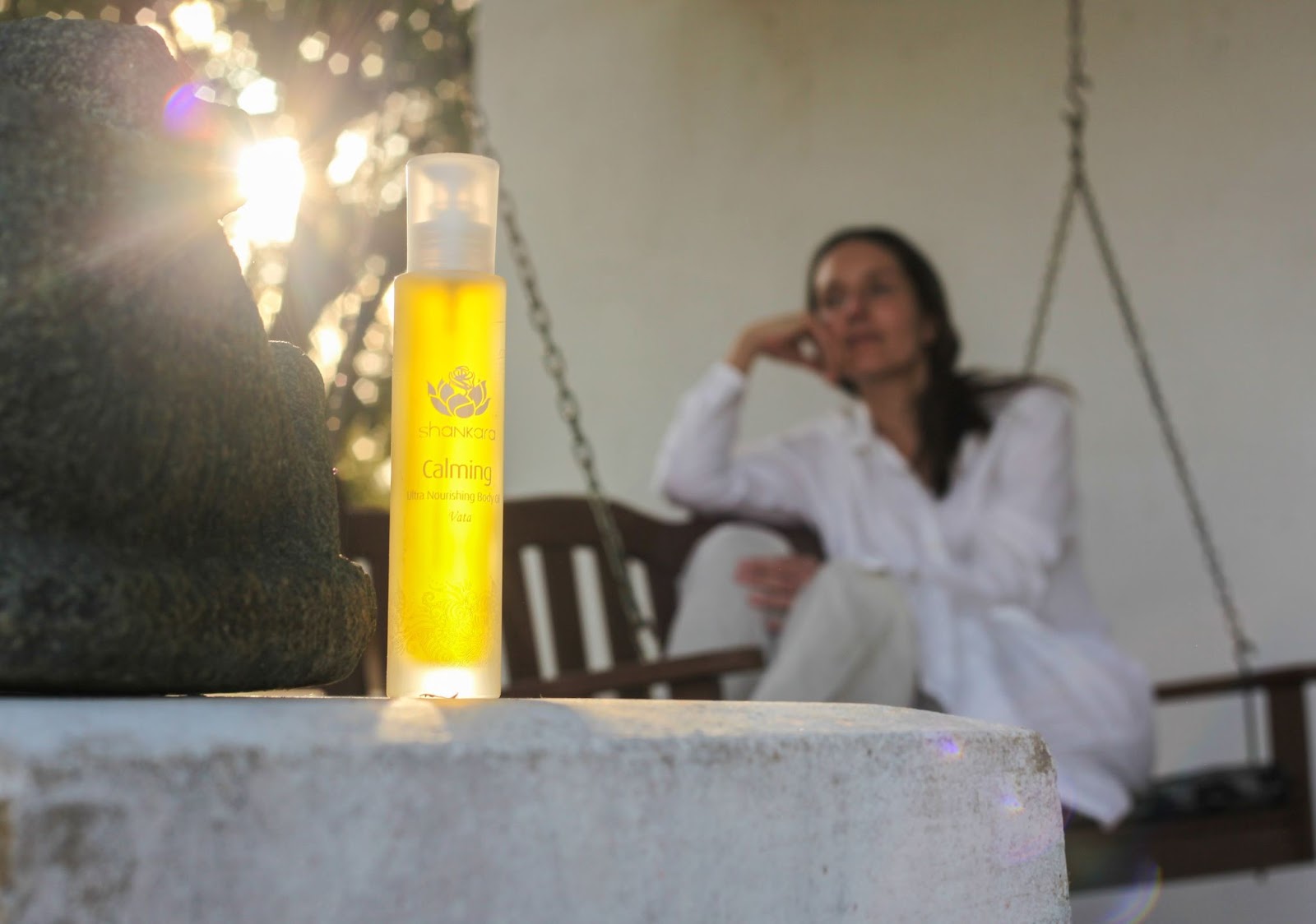 Woman relaxing outside with her Calming Oil by Shankara Naturals