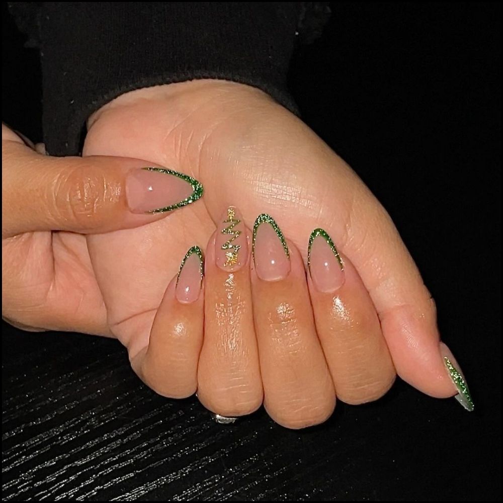 Close up of hands with Christmas Green Nails having  Frosted Green Glitter Tips