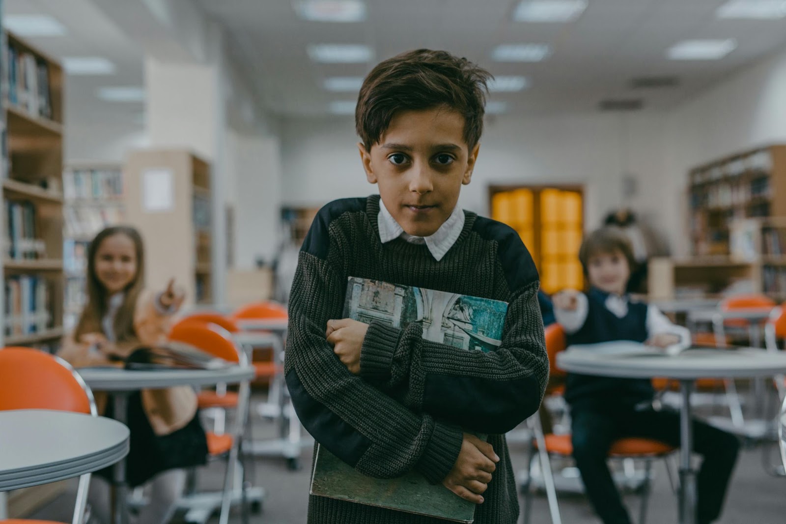 A kid walking away in shame from two bullies