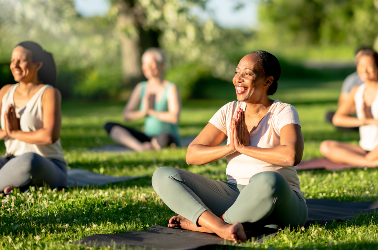 Group of individuals doing laughter yoga // Healthier Veterans Today