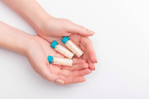 Three transparent vials filled with hormone pellets, representing hormone therapy options.