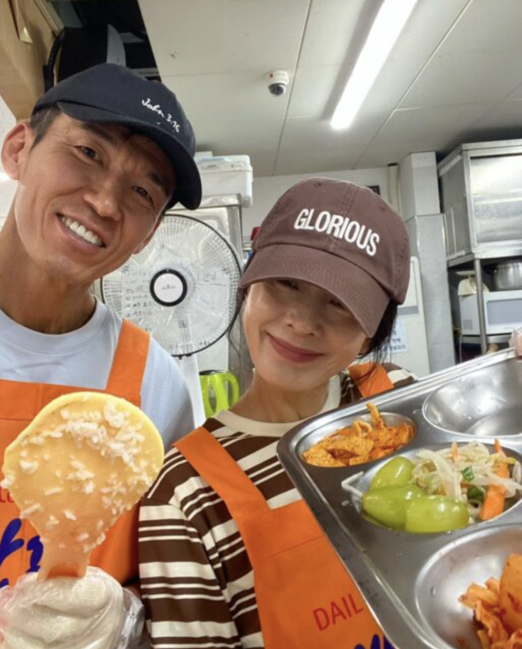 This contains an image of Sean and Jung Hye Young on their  anniversary day holding food 