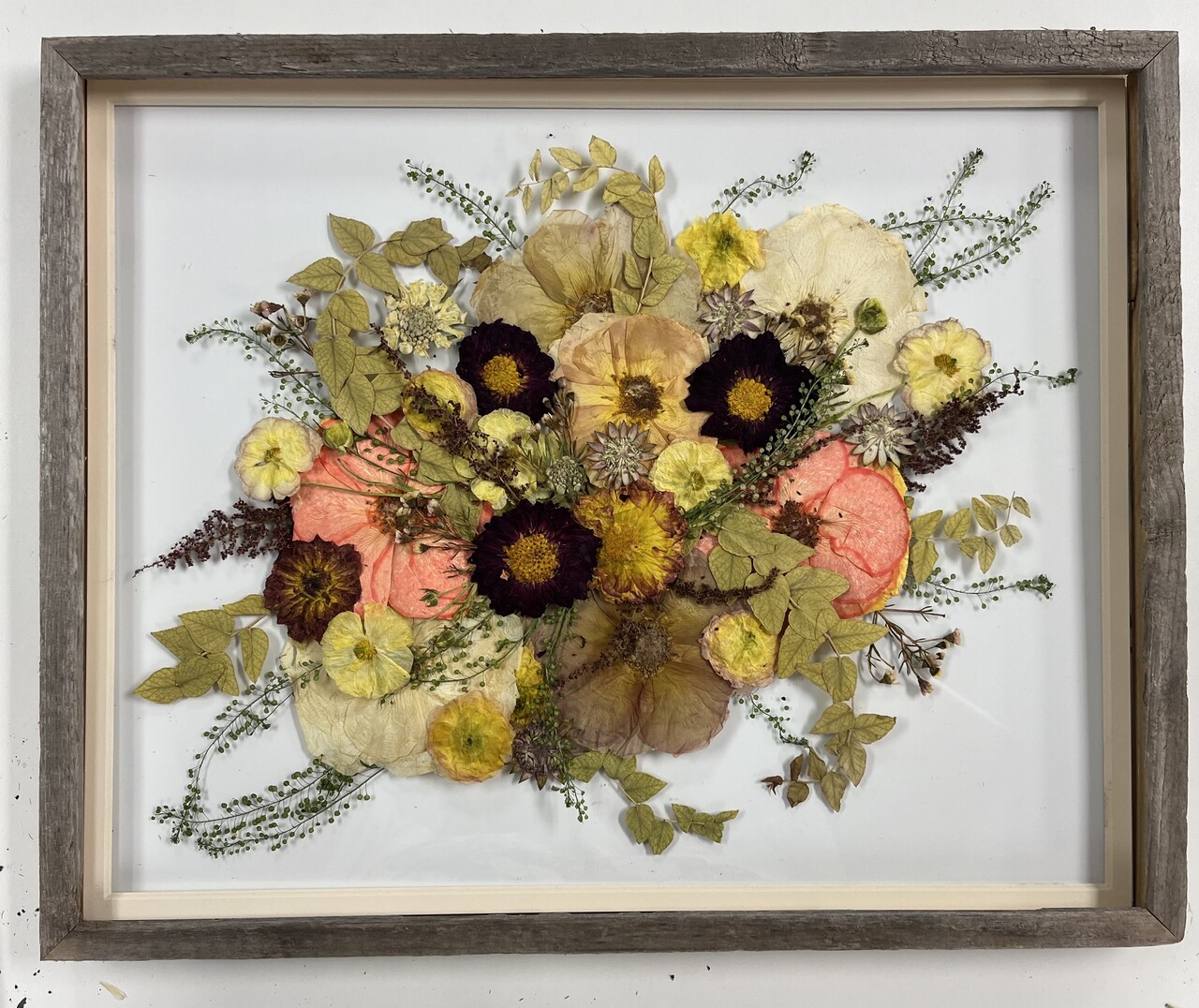 a large wood frame with orange florals preserved