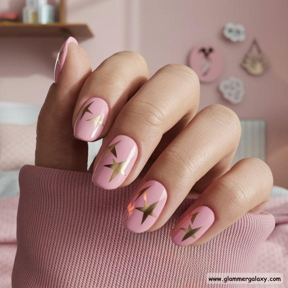 Pink Christmas Nails having Gold Star Accents on Pink Nails
