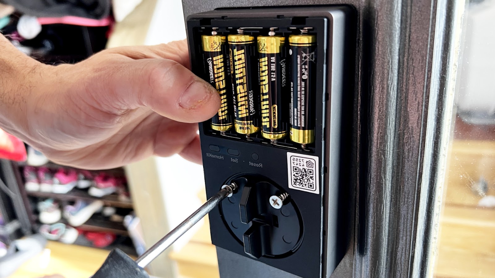 Replacing batteries in a smart lock as part of lock maintenance.